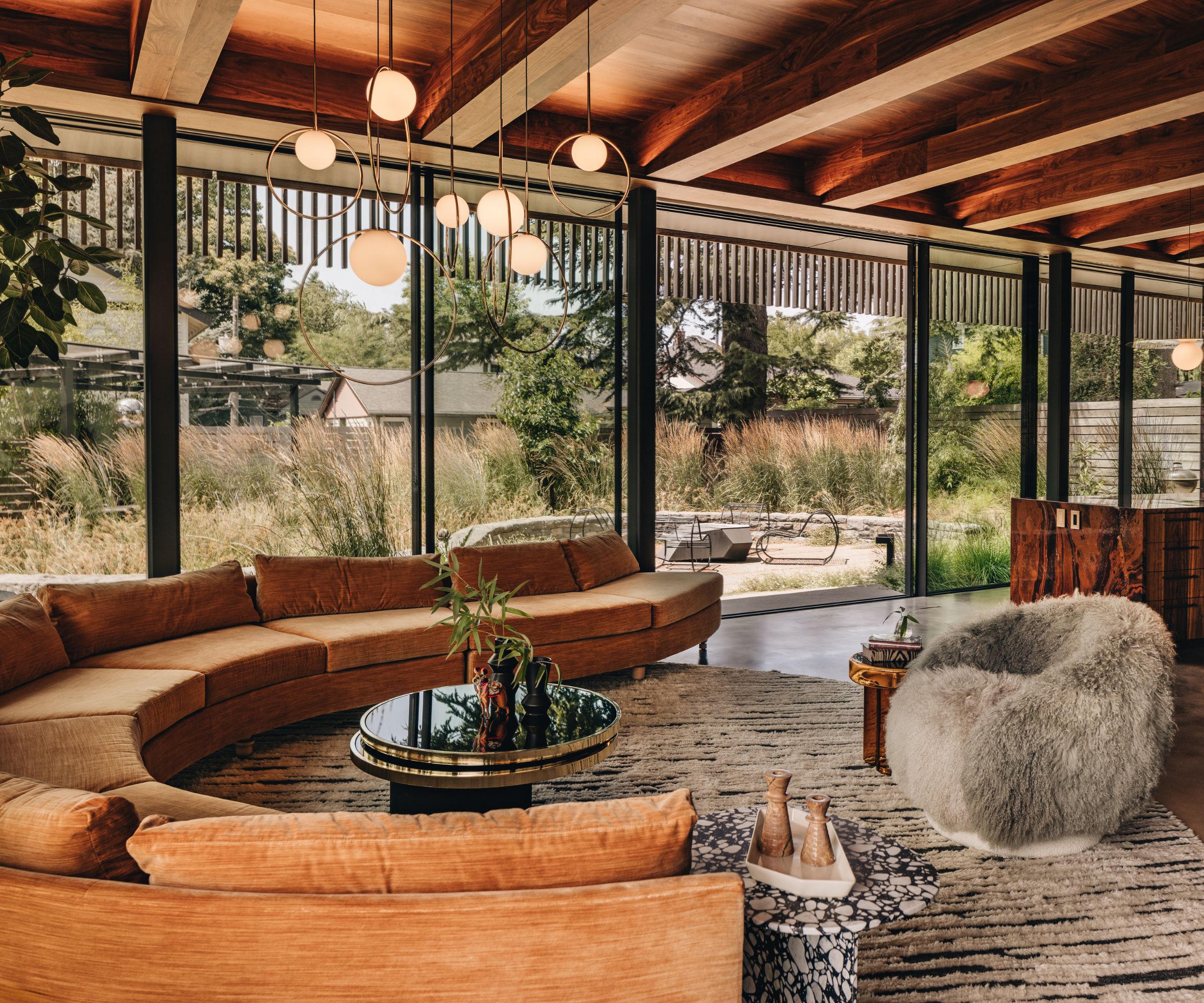 Warmly lit modern sunroom with sculptural curved seating